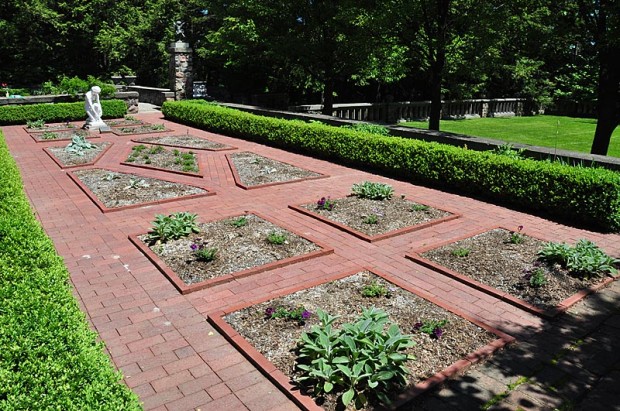 Practical and pretty: This raised brick edge keeps loose material in the beds, nudges feet aside, and looks great in this traditional herb garden at Cranbrook House and Gardens in Bloomfield Hills, Michigan.
