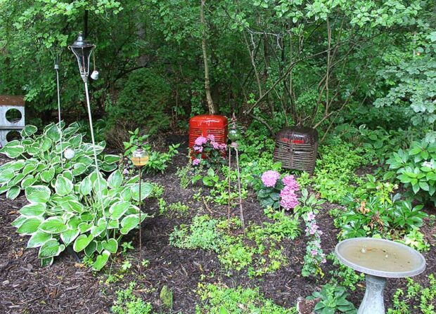 Dawn Condon uses found items and antiques to decorate the garden, including these antique tractor grills, which are brought inside for the holidays and used to hide the tree stand.