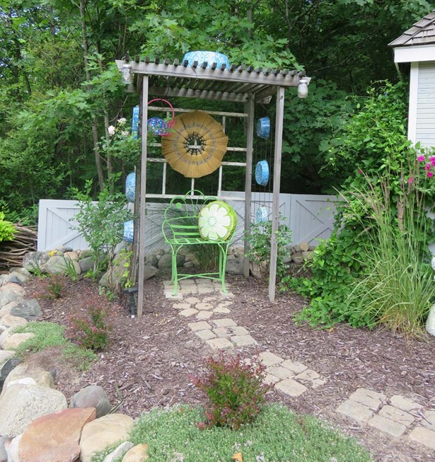 A trellis is a great place to showcase Elaine’s collection of enamel ware pans. The flower on the back wall is made from whisk brooms.