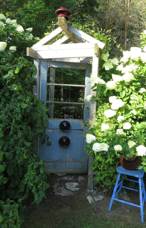 A door opens into the insulator garden and is framed by ‘Limelight’ hydrangeas.